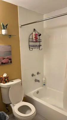 a bathroom with a white toilet and a bath tub at Villa la Morada - Live stress-free in fully furnished, all-inclusive corporate housing! in Miami