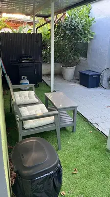 a patio with a table and a bench and a grill at Villa la Morada - Live stress-free in fully furnished, all-inclusive corporate housing! in Miami