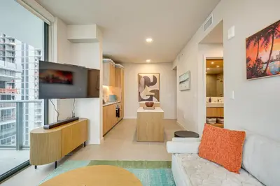 a living room with a couch and a flat screen tv at Luxe High-Rise Living! Crosby Condo with Ocean View in Miami