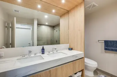 a bathroom with a sink and a toilet and a mirror at Luxe High-Rise Living! Crosby Condo with Ocean View in Miami