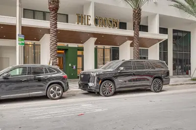 two cars parked in front of a building at Luxe High-Rise Living! Crosby Condo with Ocean View in Miami