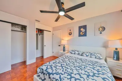 a bedroom with a bed and a ceiling fan at Hollywood Tropical Paradise vibe waterfall pool villa in Hollywood