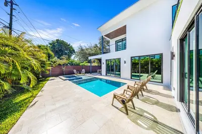 a swimming pool in the backyard of a house at Up to 10 Guests! Design District Villa in Miami