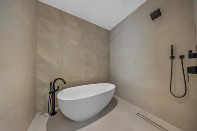 a bathroom with a white tub and a shower at Up to 10 Guests! Design District Villa in Miami