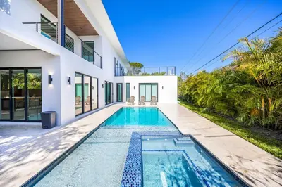 a swimming pool in the backyard of a house at Up to 10 Guests! Design District Villa in Miami