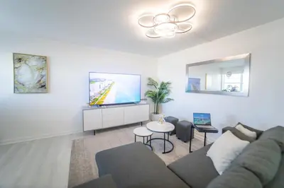 a living room with a couch and a flat screen tv at Penthouse 1BR Miami Beach, amazing Ocean and Skyline views in Miami Beach