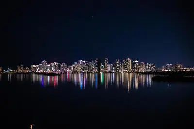 a view of a city at night from the water at Penthouse 1BR Miami Beach, amazing Ocean and Skyline views in Miami Beach