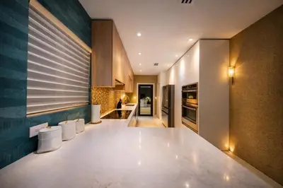a kitchen with a counter and stools in it at The Rose By Brikell in Miami