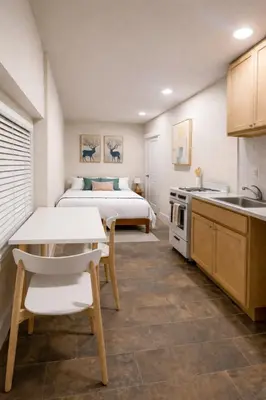 a kitchen and a bedroom with a bed and a table at Lisboa Shores in Miami