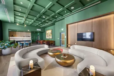 a living room with couches and a television and a piano at Luxury Urban Comfort at The Crosby Miami - Central Location in Miami
