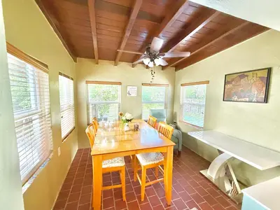a dining room with a wooden table and chairs at Coconut Villa in Hollywood