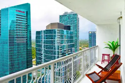 a balcony with chairs and a view of the city at Poolside Brickell Gem Stay in Miami