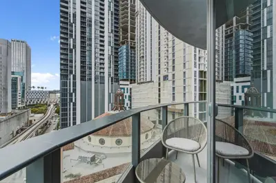 a balcony with two chairs and a view of a city at City View Condo - Prime Downtown Miami in Miami