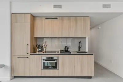 a kitchen with wooden cabinets and a sink at City View Condo - Prime Downtown Miami in Miami