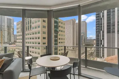 a room with a table and chairs and a view of the city at City View Condo - Prime Downtown Miami in Miami