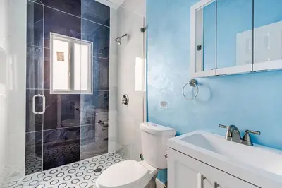 a bathroom with a shower and a toilet and a sink at Villa Shallat in Miami