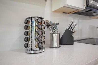 a kitchen counter with a bunch of cooking utensils at Walkable 1BR Apt near Las Olas - Fast WiFi & AC in Fort Lauderdale