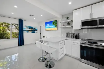 a kitchen with white cabinets and a white counter top at Walkable 1BR Apt near Las Olas - Fast WiFi & AC in Fort Lauderdale