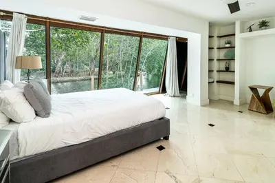 a bedroom with a large bed and a large window at Aventura Lakefront in Miami
