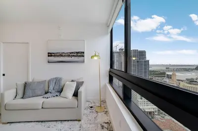 a living room with a couch and a large window at City Atelier -Sauna Pool Parking in Miami