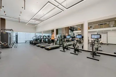a gym with several treadmills and cardio machines at City Atelier -Sauna Pool Parking in Miami