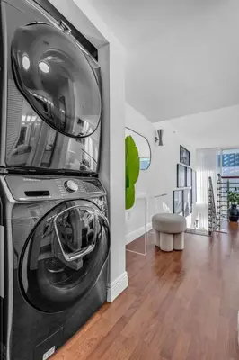 a washer and dryer in a living room at Luxury 2BD Corner Loft with Stunning Miami River View in Miami