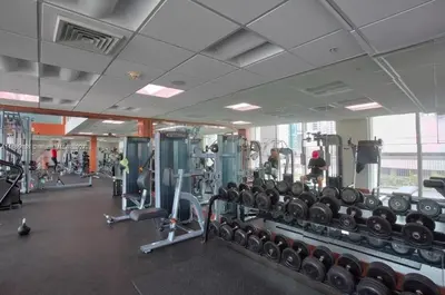 a gym with lots of machines and people in it at Luxury 2BD Corner Loft with Stunning Miami River View in Miami