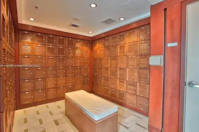 a walk in closet with wooden lockers and a bench at Luxury 2BD Corner Loft with Stunning Miami River View in Miami