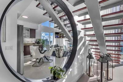 a circular staircase in a house with a round mirror at Luxury 2BD Corner Loft with Stunning Miami River View in Miami