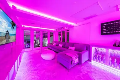 a pink living room with a couch and a table at Versace Mansion Neighbor (Floors 2 & 3) Sleeps 12 in Miami Beach
