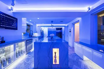a blue kitchen with a large island in the middle at Versace Mansion Neighbor (Floors 2 & 3) Sleeps 12 in Miami Beach