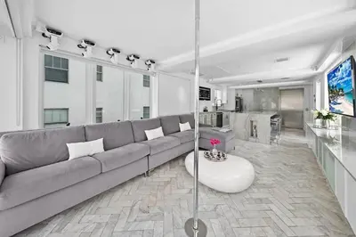 a living room with a couch and a table at Versace Mansion Neighbor (Floor 1,2,3) Sleeps 21 in Miami Beach