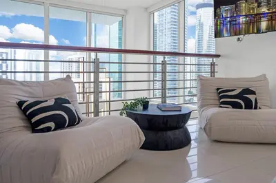 a living room with two white couches and a table at Brickell Residence 2BR Loft with amazing views in Miami