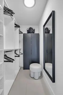 a white bathroom with a toilet and a mirror at Brickell Residence 2BR Loft with amazing views in Miami