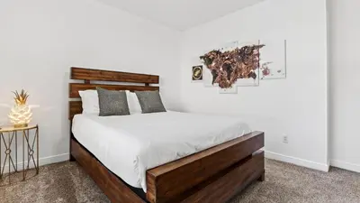 a bedroom with a large bed with a wooden headboard at Riverside Veranda by AvantStay Waterfront Stay Infinity Pool Private Dock Easy Beach Access in Dania Beach