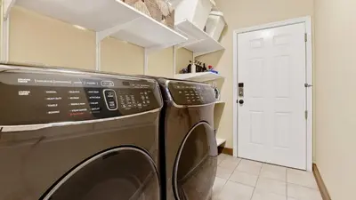 a laundry room with a washer and dryer at Riverside Veranda by AvantStay Waterfront Stay Infinity Pool Private Dock Easy Beach Access in Dania Beach