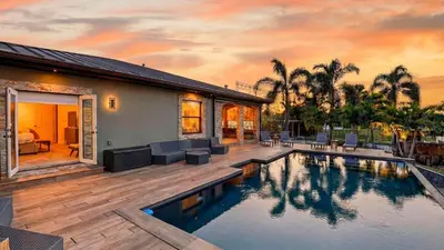 a home with a swimming pool and a house at Riverside Veranda by AvantStay Waterfront Stay Infinity Pool Private Dock Easy Beach Access in Dania Beach