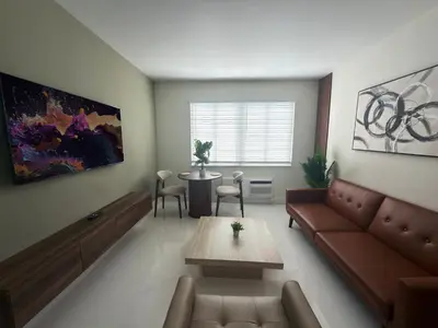 a living room with a couch and a table at MB Playa Hotel & Apartments in Miami Beach