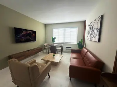 a living room with a couch and a table at MB Playa Hotel & Apartments in Miami Beach