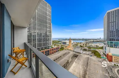 a balcony with a chair and a view of a city at Downtown Miami Cozy 1BR with Views in Miami