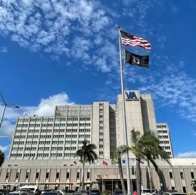 a large building with two flags in front of it at Spacious 3BR-2BA Apt near Downtown-Miami Airport in Miami