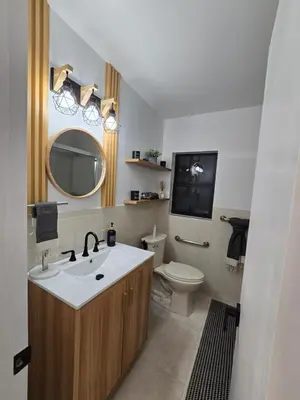 a bathroom with a sink and a toilet and a mirror at Chacon in Miami