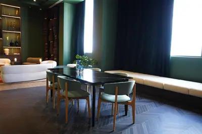 a dining room with a table and chairs and a couch at Stylish Minimalist 1BR in The Crosby in Miami