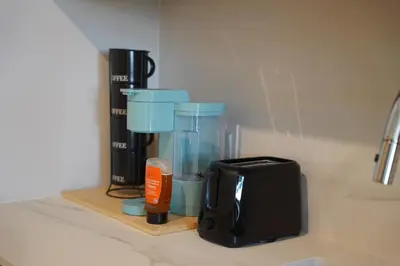a kitchen counter with a coffee maker and a blender at Stylish Minimalist 1BR in The Crosby in Miami