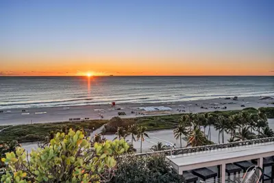 a view of the beach at sunset from a condo at Crown Jewel of Ocean Drive- 2 story Penthouse, 4 Bedrooms & Private rooftop spa in Miami Beach