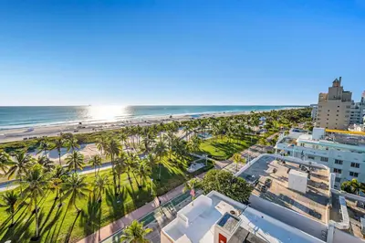 an aerial view of a beach with palm trees and buildings at Crown Jewel of Ocean Drive- 2 story Penthouse, 4 Bedrooms & Private rooftop spa in Miami Beach