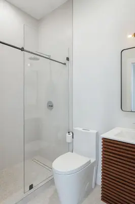 a bathroom with a toilet and a glass shower at Art District Stay Wynwood & Design District Nearby in Miami