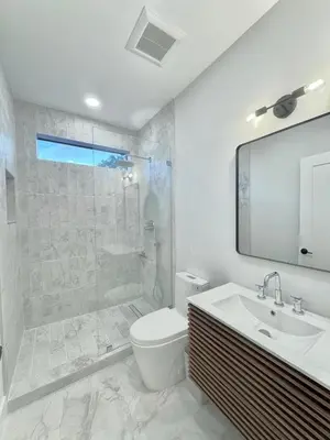 a bathroom with a shower and a toilet and a sink at Art District Stay Wynwood & Design District Nearby in Miami