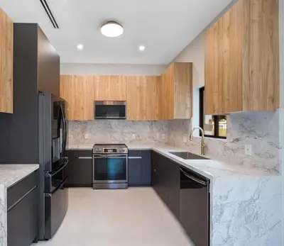 a kitchen with wooden cabinets and a blue appliance at Art District Stay Wynwood & Design District Nearby in Miami