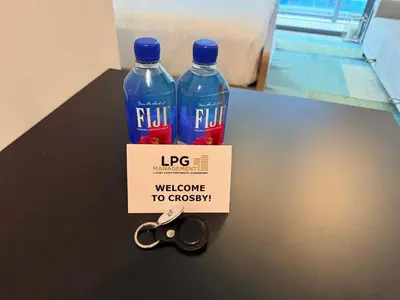 two bottles of water sitting on a table with scissors at Brand new Studio at The Crosby Miami Worldcenter in Miami